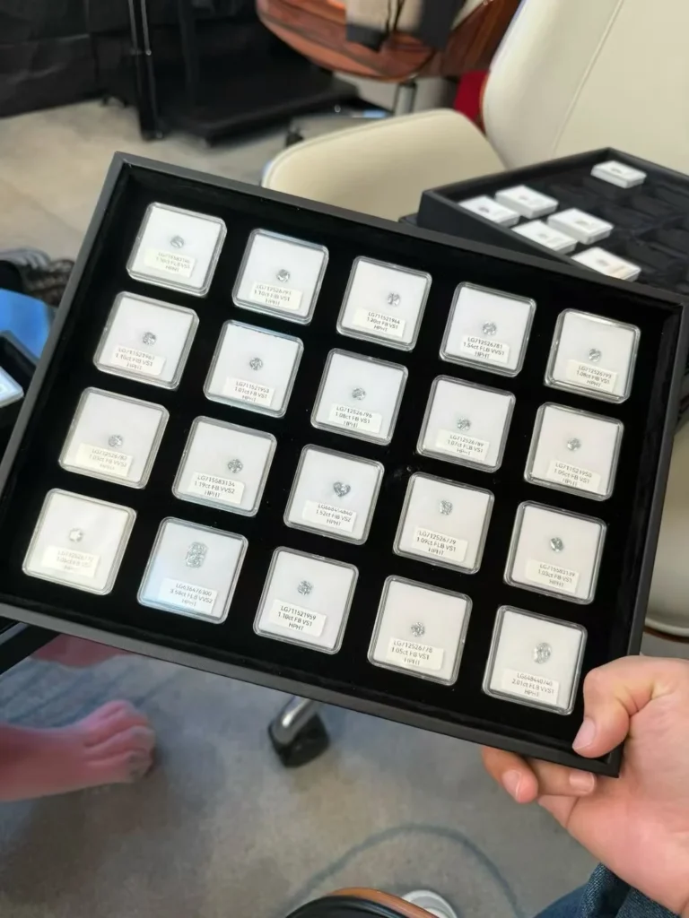 A tray of individually boxed diamonds arranged for selection.